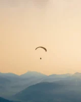 A paraglider soars gracefully over - Credits: pexels