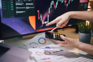 Hands analyzing stock market data - Credits: pexels