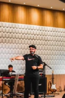 Musician performs on stage with - Credits: pexels