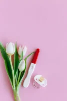 Positive pregnancy test with tulips - Credits: pexels