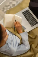 A woman sits on a - Credits: pexels