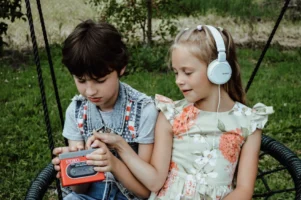 Two kids listening to music - Credits: pexels