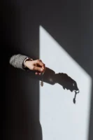 Hand with a key casting - Credits: pexels