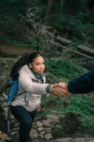 A young black woman receives - Credits: pexels