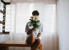 Woman sitting on a wooden - Credits: pexels