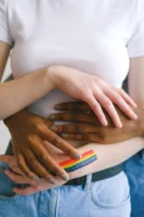 Close-up of diverse hands embracing - Credits: pexels