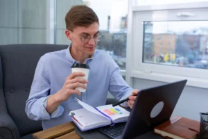 Business professional sipping coffee while - Credits: pexels