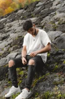 Fashionable young man sitting on - Credits: pexels