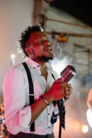 Charismatic singer passionately performing with - Credits: pexels