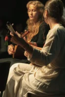 Two women playing guitars in - Credits: pexels