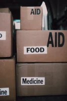 Close-up of aid packages with - Credits: pexels