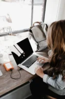 A young woman works remotely - Credits: pexels