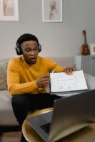 A man teaching music online, - Credits: pexels