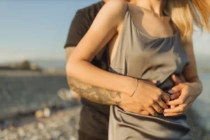 A romantic couple embracing by - Credits: pexels