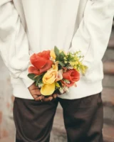 Person holding a bouquet of - Credits: pexels
