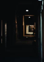 A dimly lit alleyway with - Credits: pexels