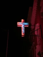 A glowing neon cross sign - Credits: pexels
