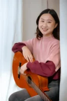 A cheerful young woman playing - Credits: pexels