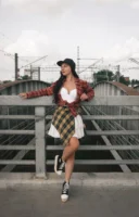 Woman in urban attire poses - Credits: pexels