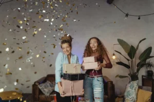 Two women rejoicing amidst confetti - Credits: pexels