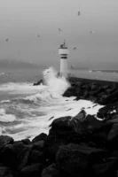 Powerful waves crash against a - Credits: pexels