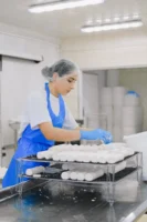 Woman worker in cheese production - Credits: pexels