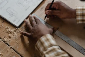 Hands of a craftsman measuring - Credits: pexels