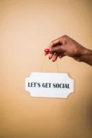 A hand holding a "Let's - Credits: pexels
