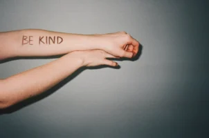 Arm with 'Be Kind' message - Credits: pexels