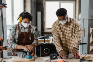 Two craftsmen wearing protective gear - Credits: pexels
