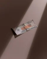A torn dollar bill patched - Credits: pexels