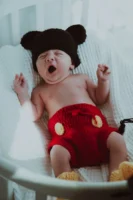 Cute baby yawning in a - Credits: pexels