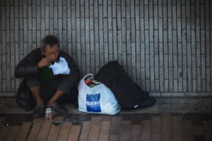 Elderly man sitting on city - Credits: pexels