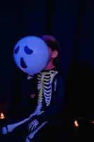 Child in skeleton costume holds - Credits: pexels