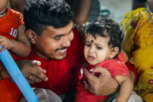 A father lovingly comforts a - Credits: pexels