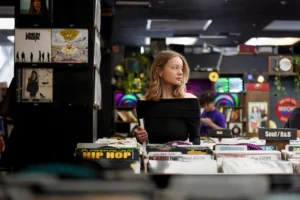 A young woman browsing records - Credits: pexels