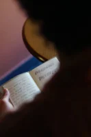 A person reads a notebook - Credits: pexels