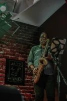 Musician playing saxophone on stage - Credits: pexels