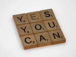 Wooden Scrabble tiles on white - Credits: pexels