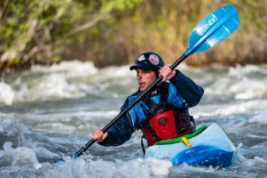 An adventurous kayaker navigates wild - Credits: pexels