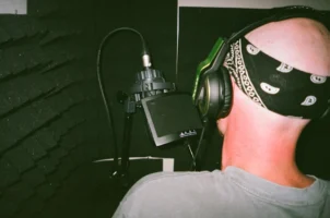 Bald musician recording vocals in - Credits: pexels
