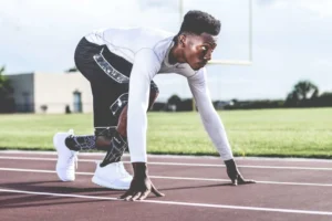 Focused athlete in starting position - Credits: pexels