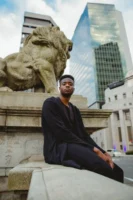Confident young man seated near - Credits: pexels