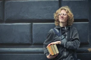 A smiling young man with - Credits: pexels