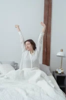 A woman in pajamas stretching - Credits: pexels