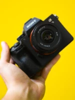 A black camera held in - Credits: pexels