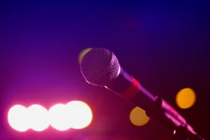 Colorful stage lighting highlights a - Credits: pexels