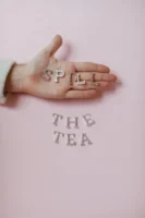 Hand holding 'SPILL' letters with - Credits: pexels