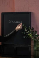 A hand writes 'Goodbye' on - Credits: pexels