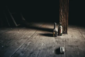 Dusty bottles in a dark - Credits: pexels